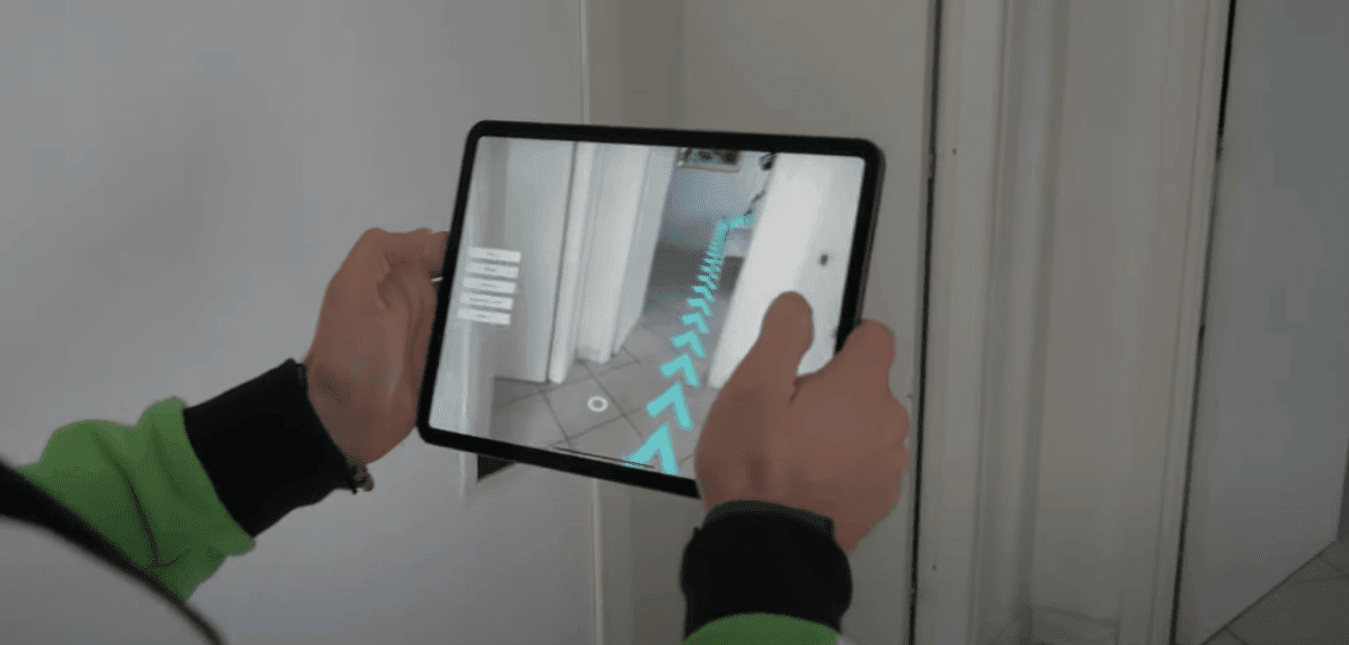 Employee navigating a warehouse with the help of an AR app